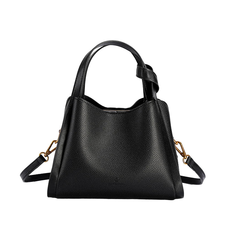 Black handbag with gold accents on a white background