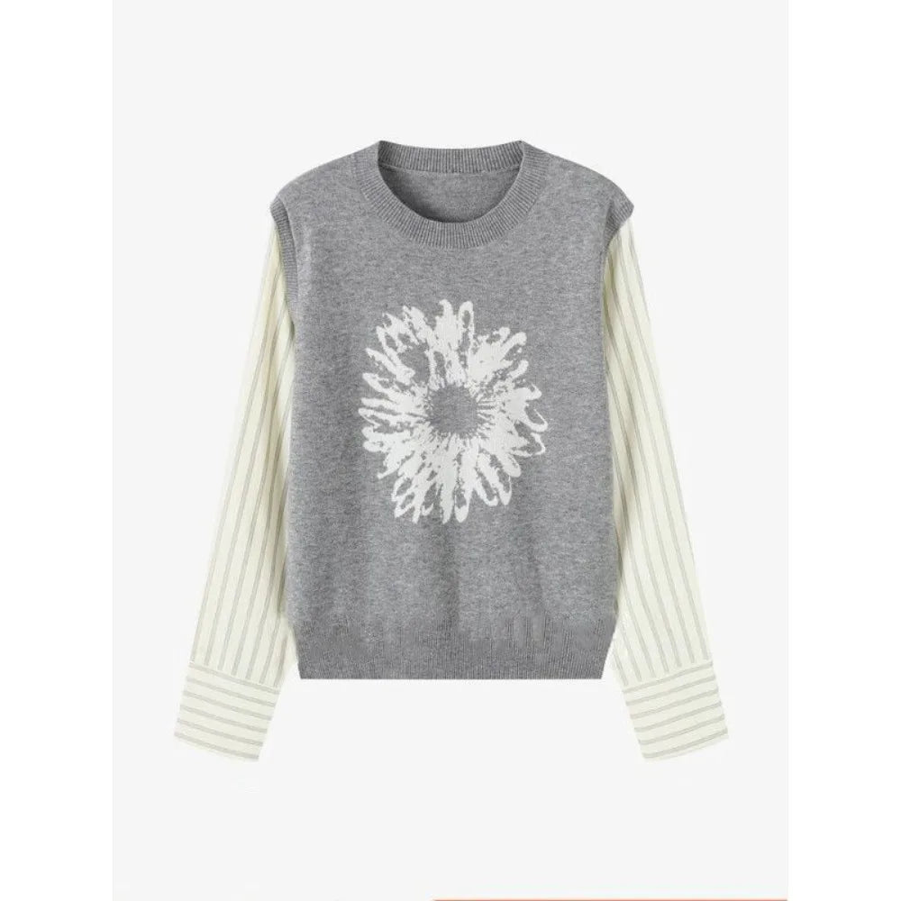 Gray sleeveless sweater with white floral design on a white background