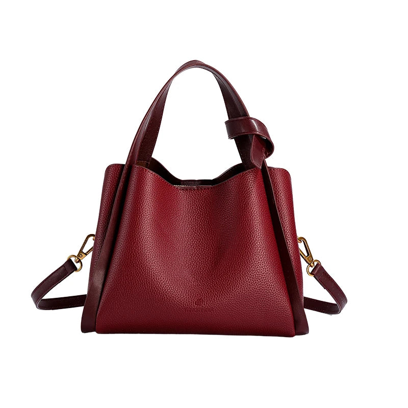 Red handbag with gold accents on a white background