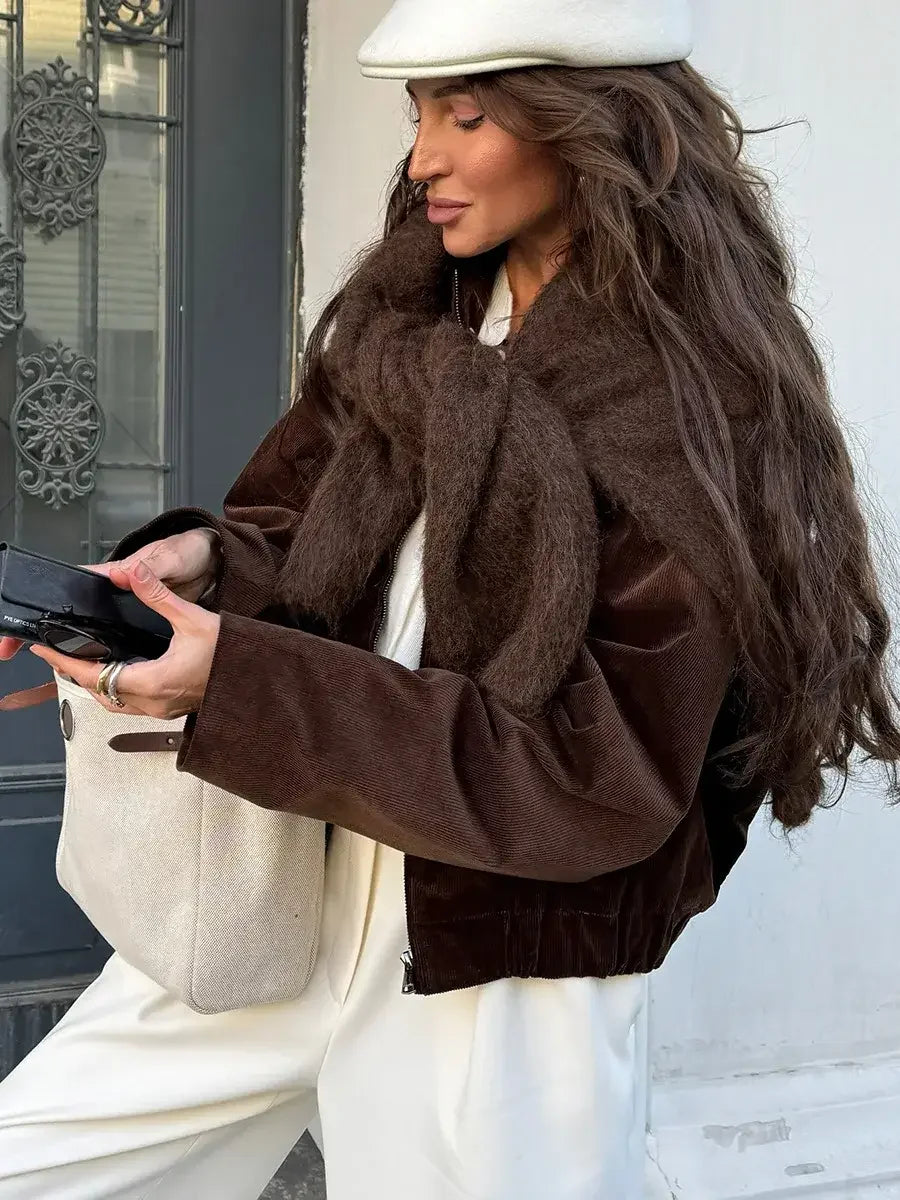 Woman in a brown jacket and white beret with a beige tote bag, wearing chic fall fashion.