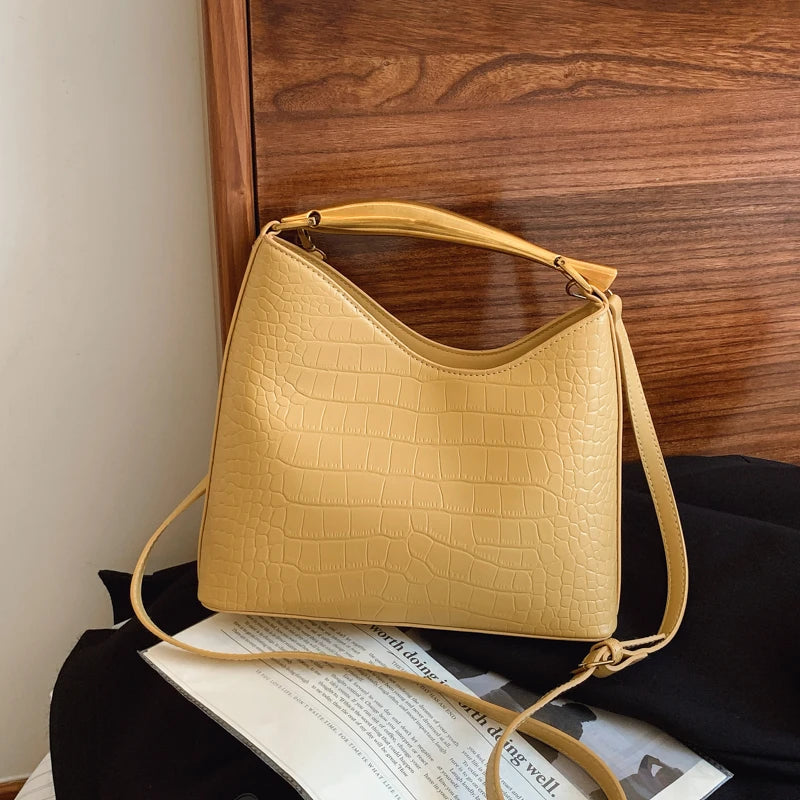 Yellow handbag on a surface with a wooden background