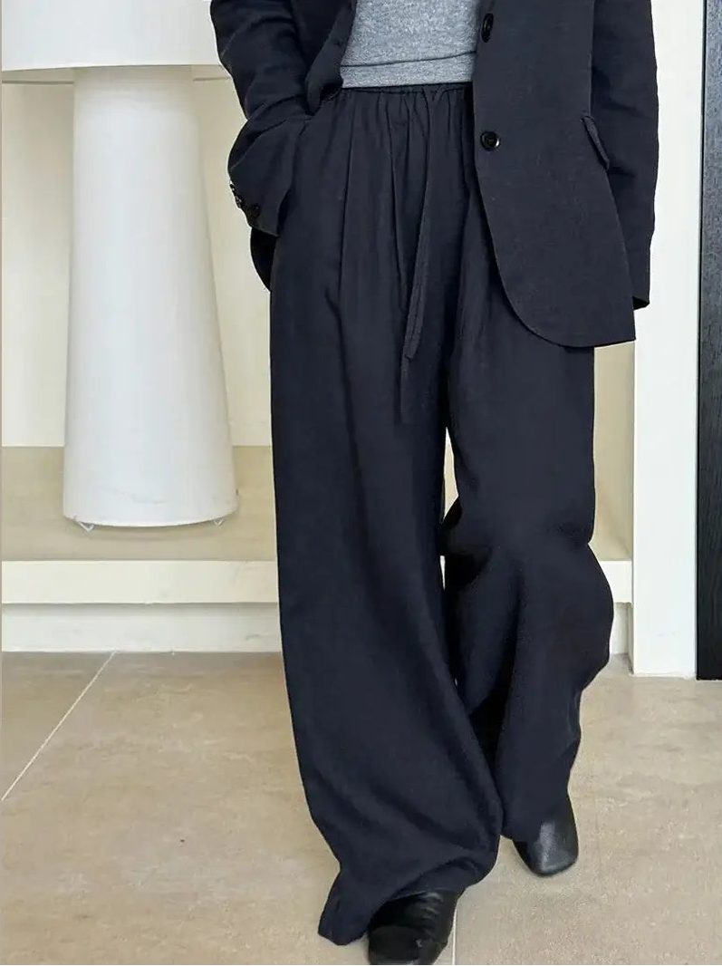 Person wearing a blue suit with wide-leg pants indoors.