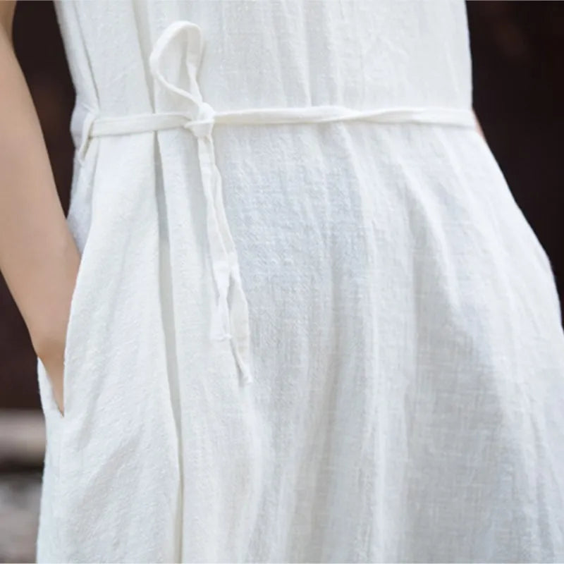 Close-up of textured cotton ramie weave showing crew neckline and side-tie bandage detail