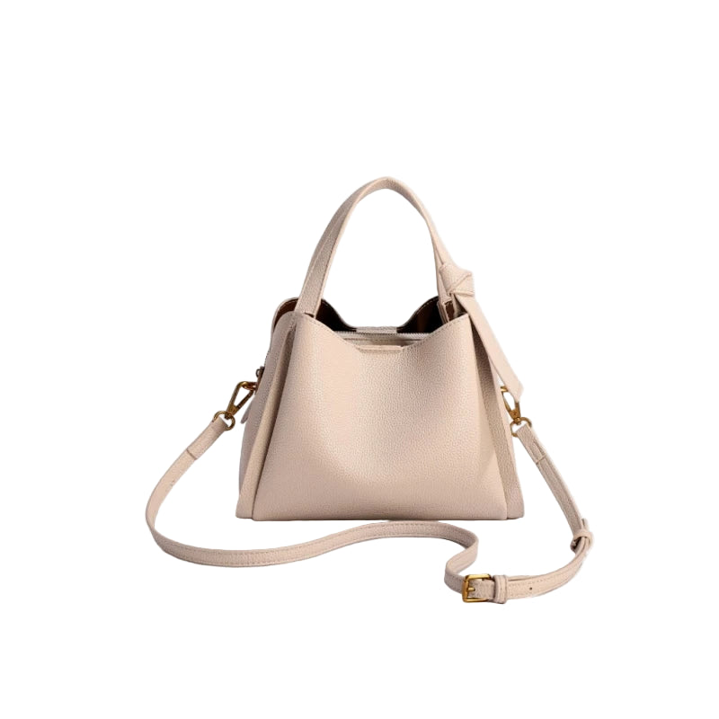 Beige handbag with a strap on a white background