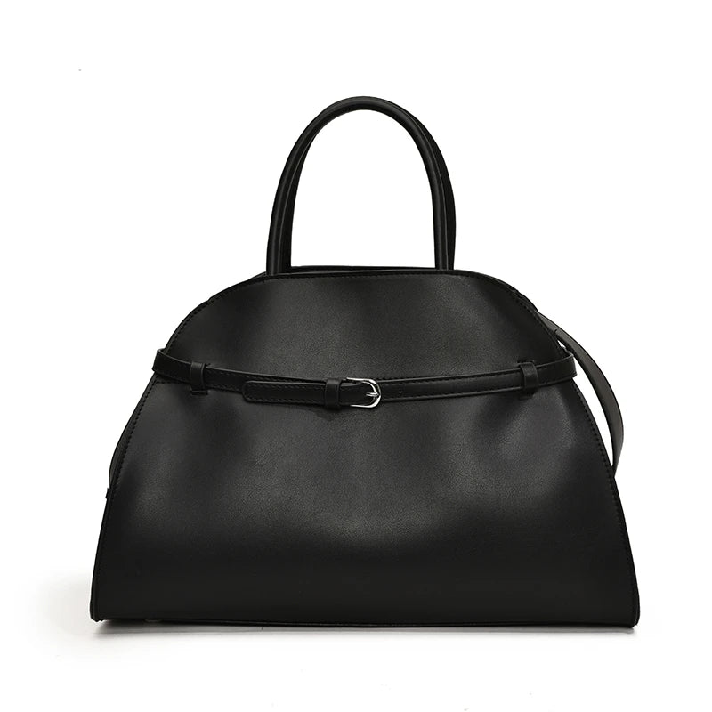 Black handbag with a strap on a white background