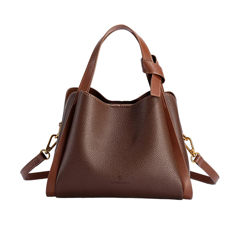Brown leather handbag with gold chain detail on a white background