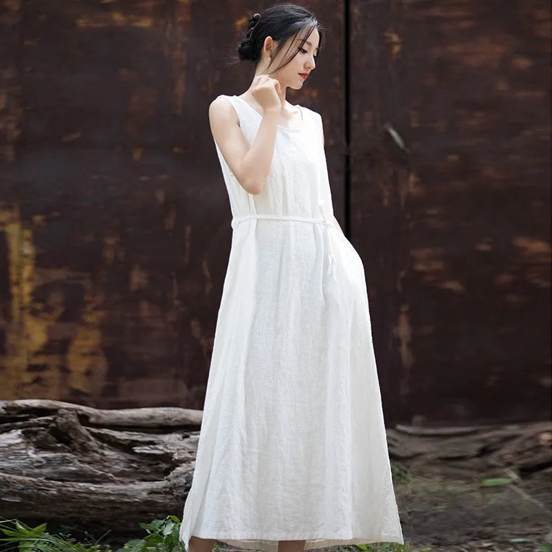 Front view of woman wearing sleeveless loose-fit cotton ramie midi dress in neutral tone
