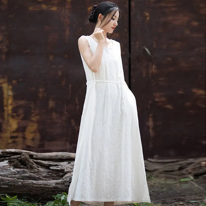 Front view of woman wearing sleeveless loose-fit cotton ramie midi dress in neutral tone
