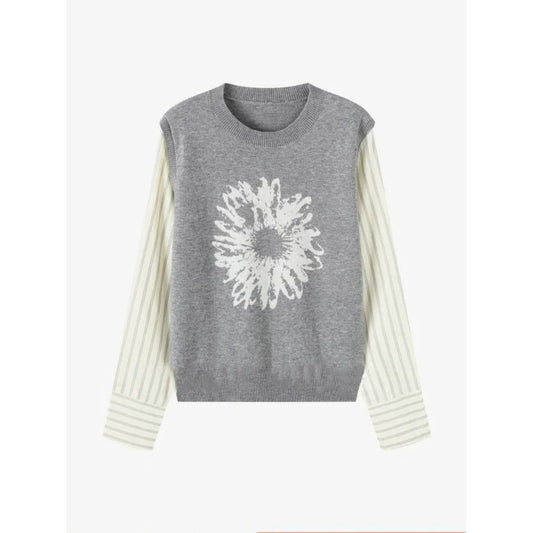 Gray sleeveless sweater with white floral design on a white background