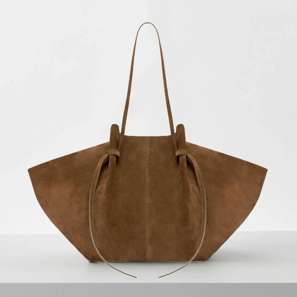 Brown suede handbag on a white background