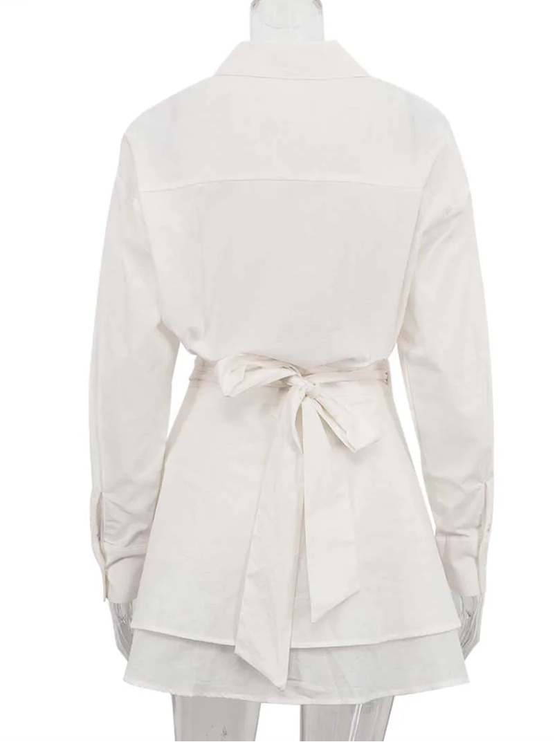 White tunic with a belt on a mannequin against a white background
