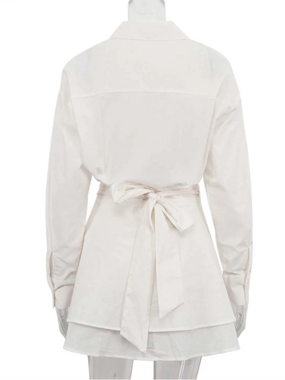 White tunic with a belt on a mannequin against a white background