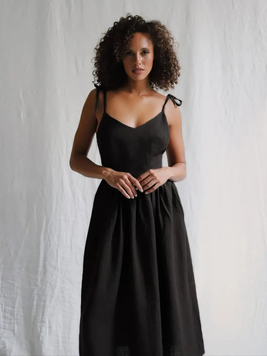 Woman wearing a black dress against a white background