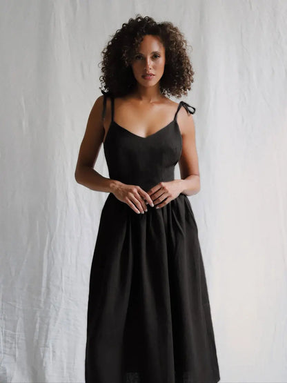 Woman wearing a black dress against a white background