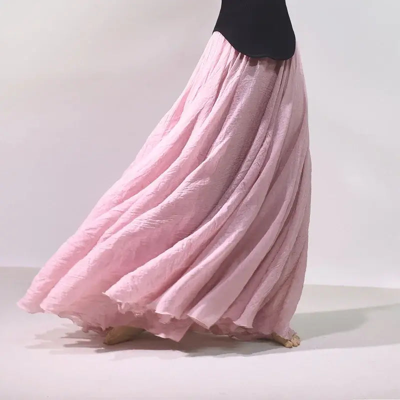 Pink long skirt with a black top on a light background