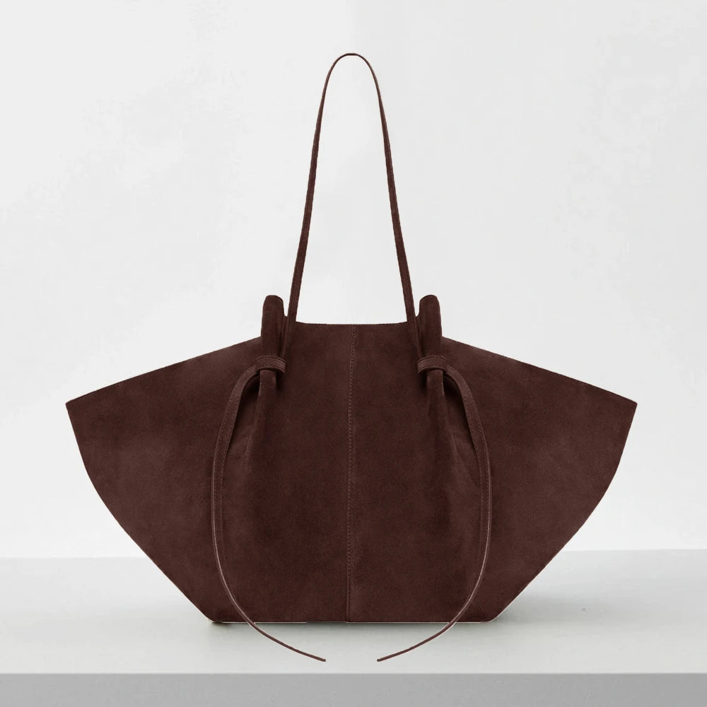 Brown suede handbag on a white background