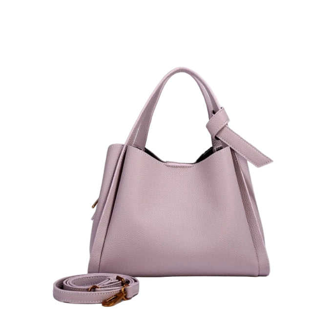 Pink handbag with a strap on a white background