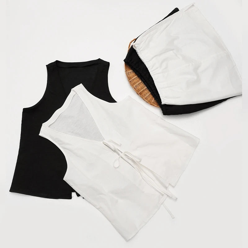 Black tank top and white robe on a light gray background