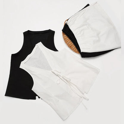Black tank top and white robe on a light gray background