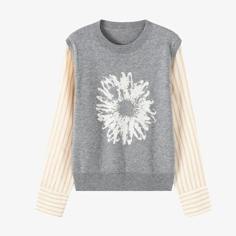 Gray sleeveless sweater with a white floral design on a white background
