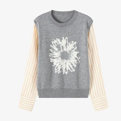 Gray sleeveless sweater with a white floral design on a white background