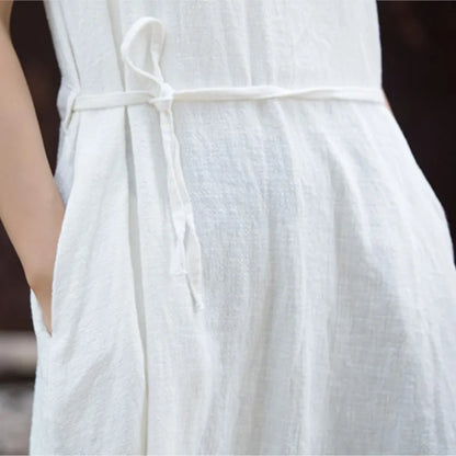 Close-up of textured cotton ramie weave showing crew neckline and side-tie bandage detail