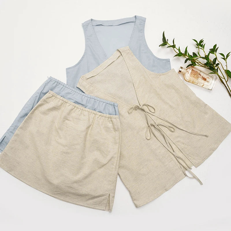 Light blue sleeveless top and beige shorts on a white background with a plant and bottle.