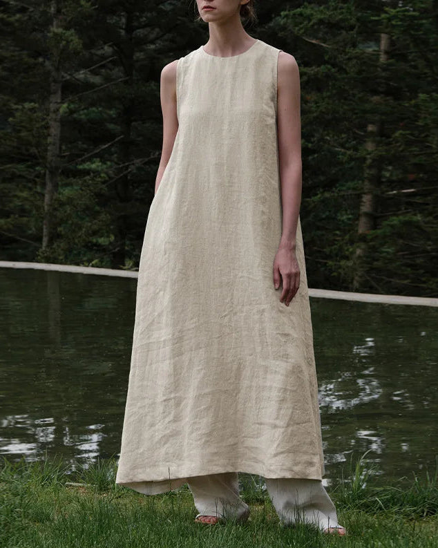 Lifestyle shot of the effortless linen-blend long dress flowing naturally in the summer breeze.