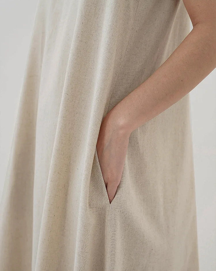 Lifestyle shot of the effortless linen-blend long dress flowing naturally in the summer breeze.