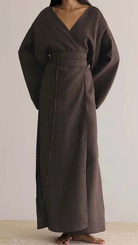 Brown long dress worn by a person on a plain background